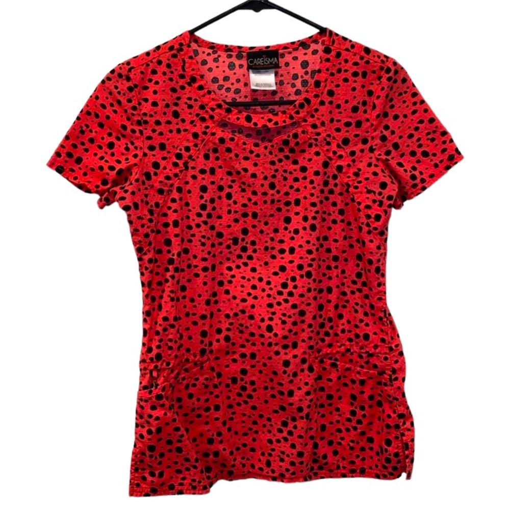 Women’s Careisma Peachy/Pink Scrub Top With Black Dot Pattern. Size X-Small.